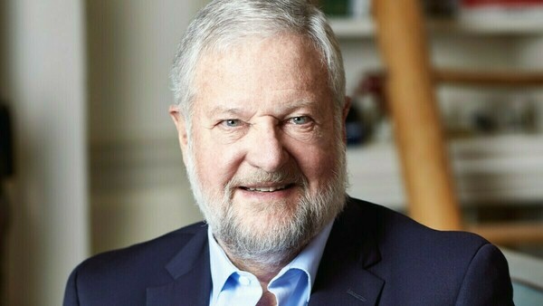 David Rockefeller Jr. waring a navy suit and light blue collared shirt